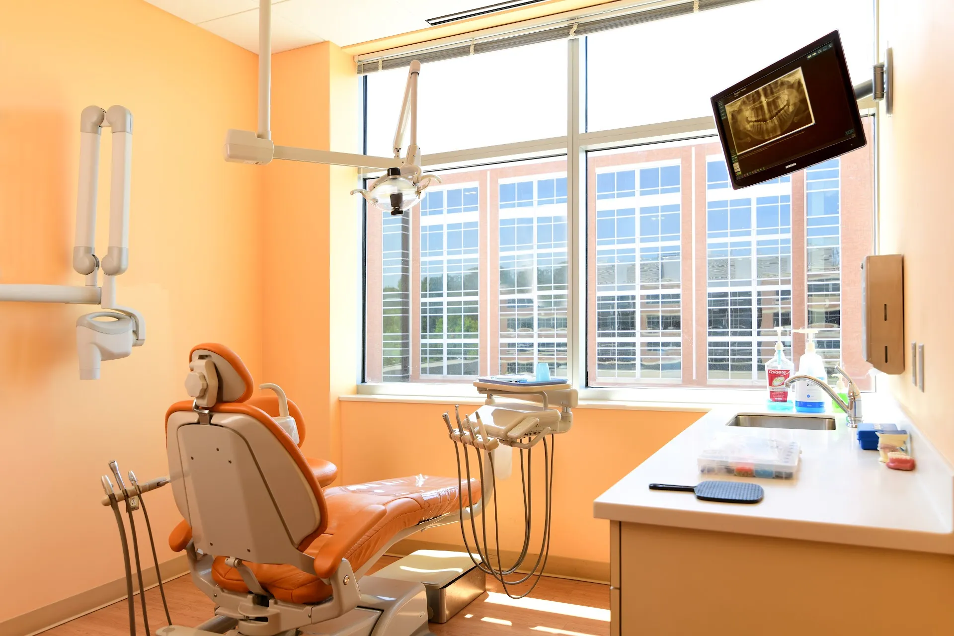 Treatment room with dental chair and panoramic windows at Capital Dental Sibley